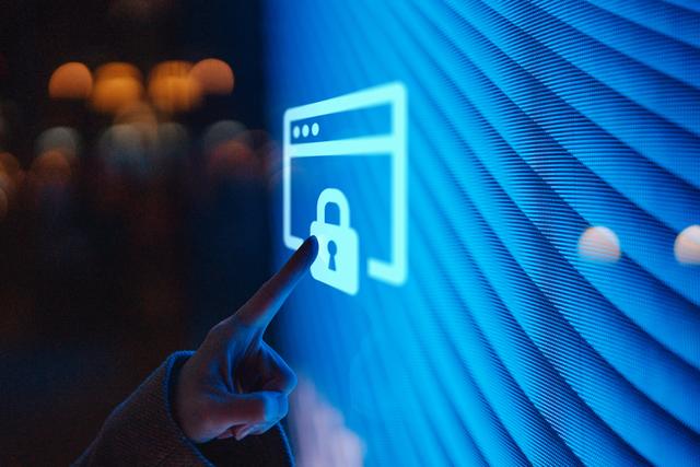 Close-up of  female hand touching illuminated digital screen displaying a locked sign.jpg